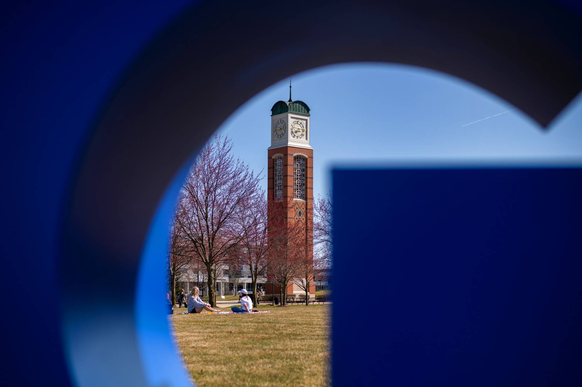 The Allendale Campus Cook-Carillon Tower framed within the letter G from the GVSU fixture